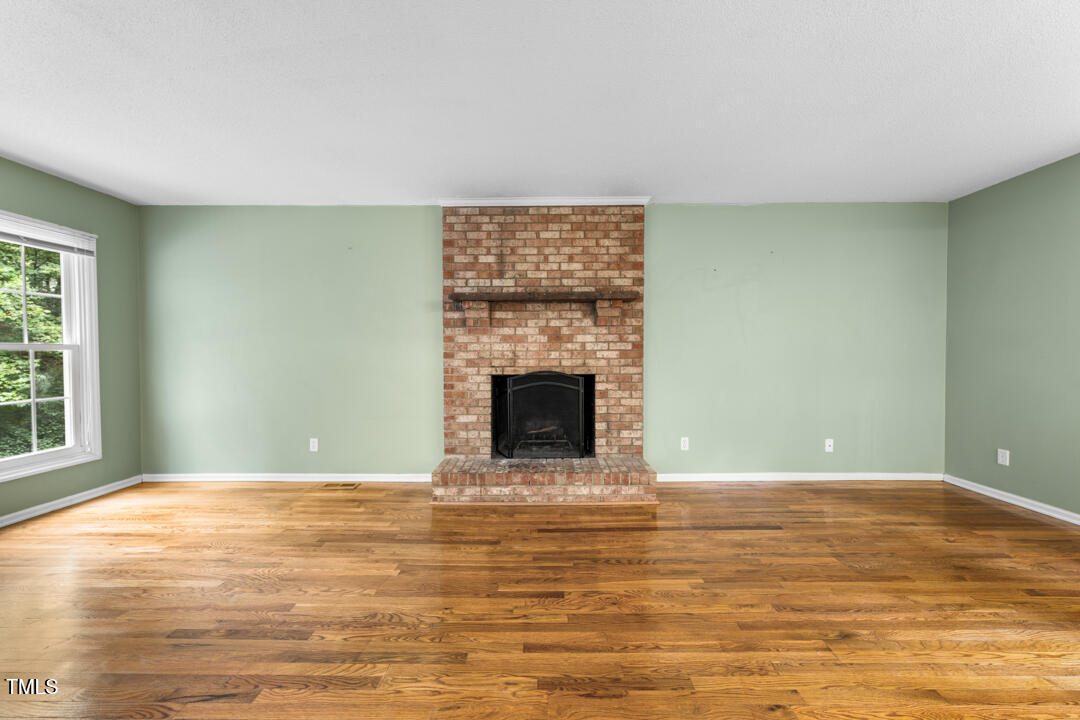 122 Stedwick Place Durham, NC 27712 - Photo 7 of 35 a view of an empty room with window and fire place