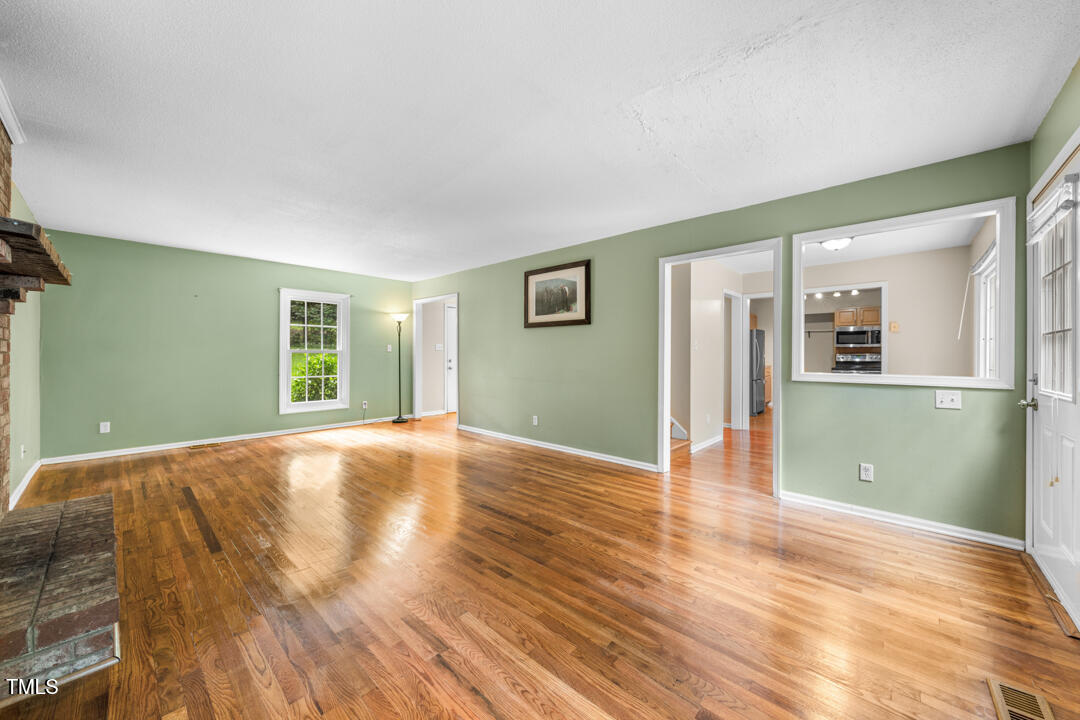 122 Stedwick Place Durham, NC 27712 - Photo 8 of 35 a view of a livingroom with wooden floor