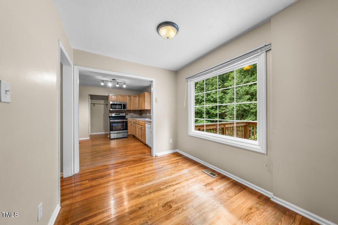122 Stedwick Place Durham, NC 27712 - Photo 10 of 35 a view of a room with wooden floor and a window