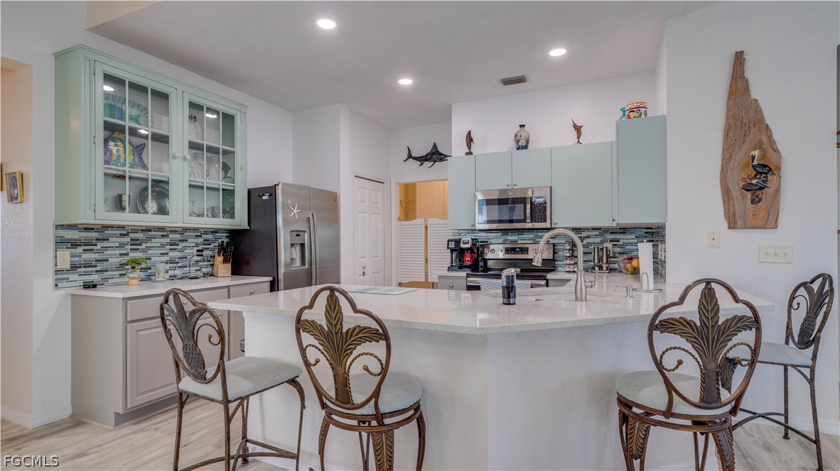 3181 Matecumbe Key Road, Unit 4 Punta Gorda, FL 33955 - Photo 12 of 50 a kitchen with stainless steel appliances granite countertop a table and chairs