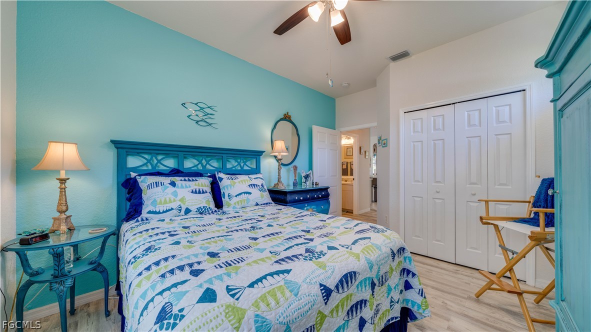 3181 Matecumbe Key Road, Unit 4 Punta Gorda, FL 33955 - Photo 19 of 50 a bedroom with a bed and a chandelier