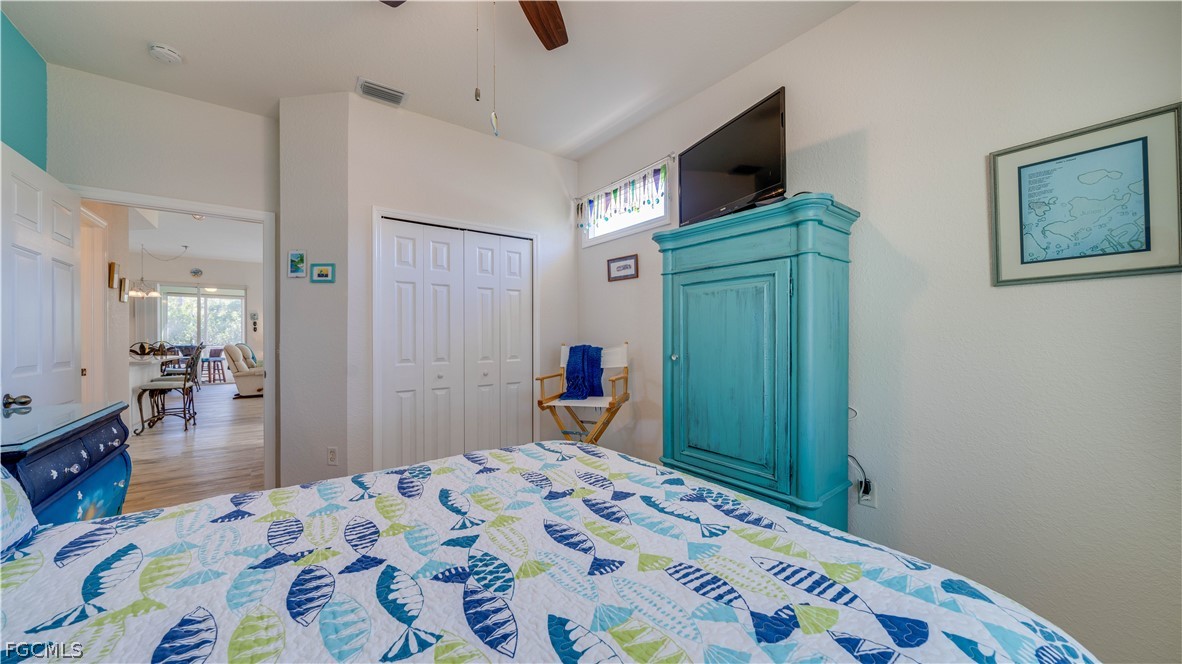 3181 Matecumbe Key Road, Unit 4 Punta Gorda, FL 33955 - Photo 20 of 50 a bedroom with a bed and wooden floor