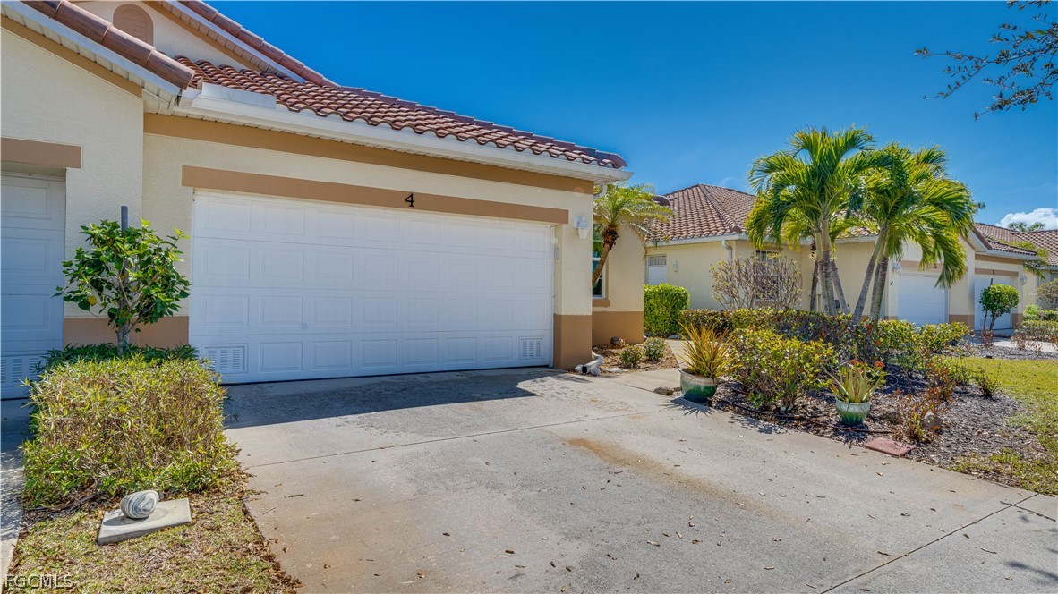 3181 Matecumbe Key Road, Unit 4 Punta Gorda, FL 33955 - Photo 2 of 50 a front view of a house with a yard