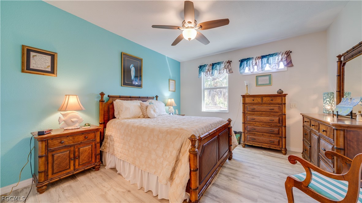 3181 Matecumbe Key Road, Unit 4 Punta Gorda, FL 33955 - Photo 22 of 50 a bedroom with a bed and a chandelier