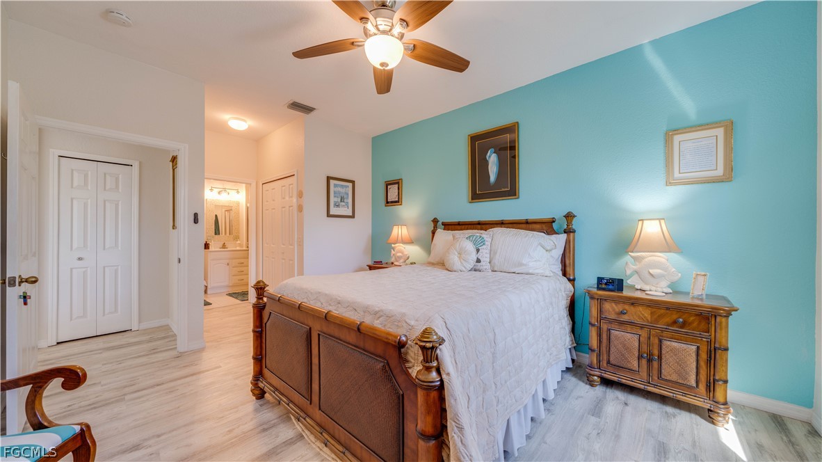 3181 Matecumbe Key Road, Unit 4 Punta Gorda, FL 33955 - Photo 23 of 50 a spacious bedroom with a bed and a chandelier