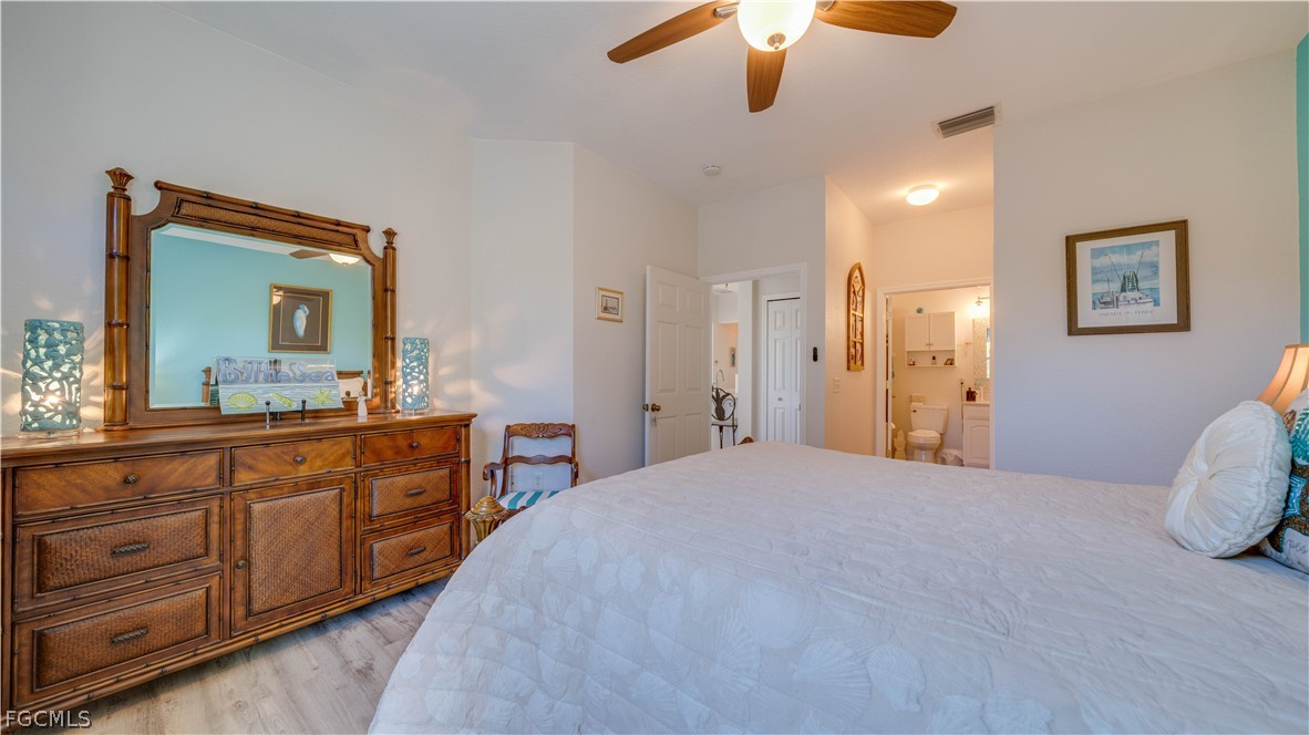 3181 Matecumbe Key Road, Unit 4 Punta Gorda, FL 33955 - Photo 24 of 50 a spacious bedroom with a large bed and a chandelier