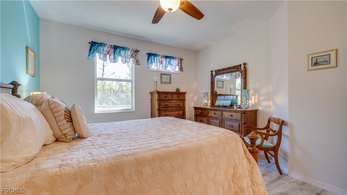 3181 Matecumbe Key Road, Unit 4 Punta Gorda, FL 33955 - Photo 25 of 50 a bedroom with a bed and a chandelier