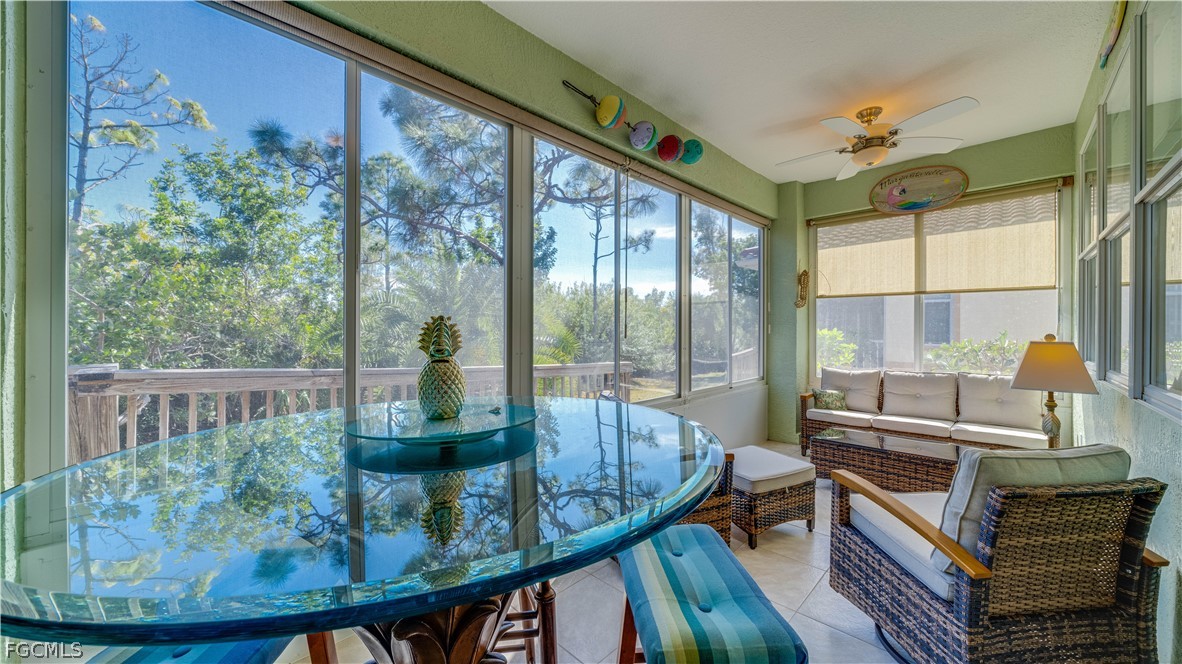 3181 Matecumbe Key Road, Unit 4 Punta Gorda, FL 33955 - Photo 27 of 50 a view of a dining room with furniture large windows and wooden floor