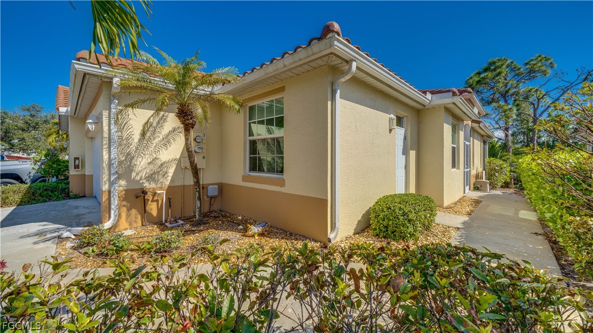 3181 Matecumbe Key Road, Unit 4 Punta Gorda, FL 33955 - Photo 31 of 50 a front view of a house with a yard