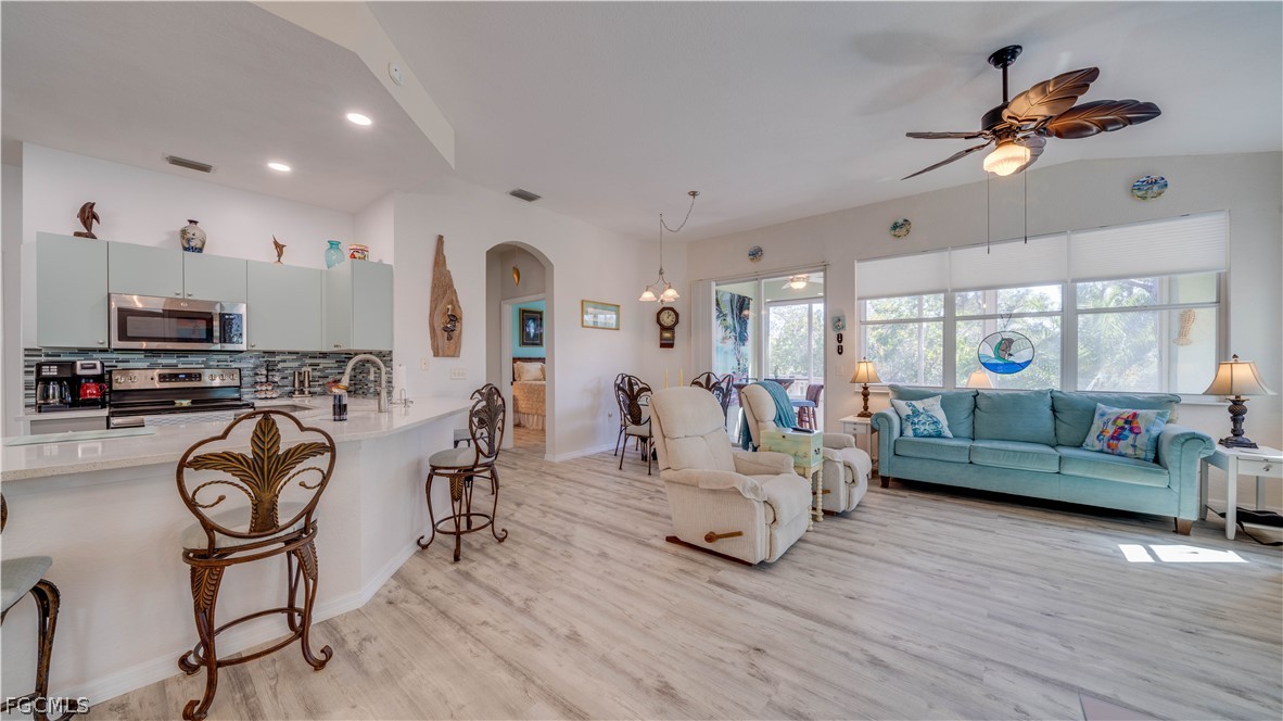 3181 Matecumbe Key Road, Unit 4 Punta Gorda, FL 33955 - Photo 4 of 50 a living room with furniture and a wooden floor