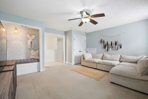 a living room with furniture and a glass door