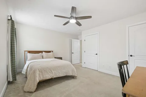 a bedroom with a bed and a chandelier