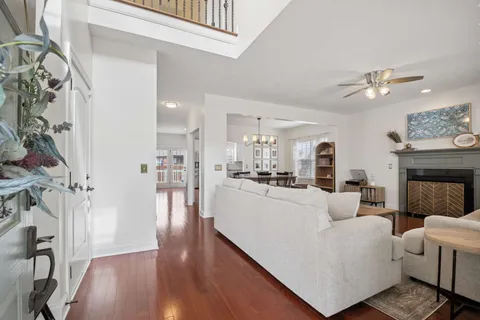a living room with furniture a fireplace and wooden floor