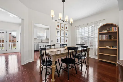 a view of a a dining room with furniture window and wooden floor