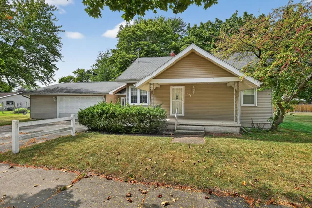 a front view of house with yard and green space