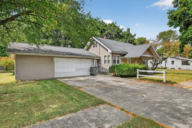 a backyard of a house with yard and outdoor seating