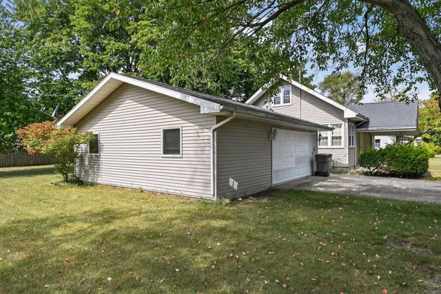 a view of a house with a yard and garage