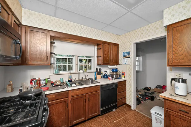 a kitchen with a sink stove and cabinets