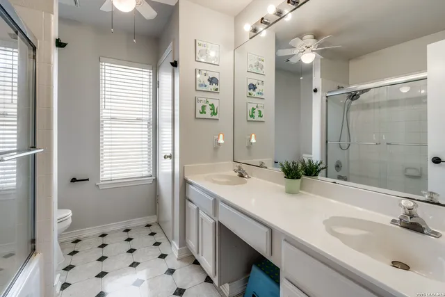 a bathroom with a sink double vanity and a shower