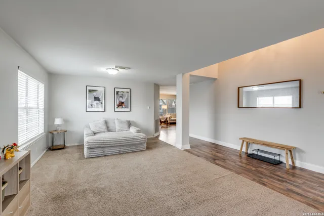 a living room with furniture and a potted plant on table