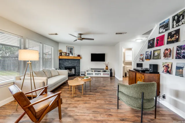 a living room with fireplace furniture and a flat screen tv