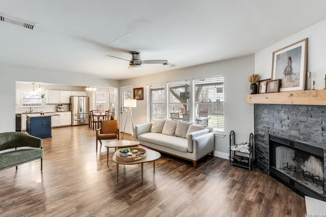 a living room with furniture and a fireplace