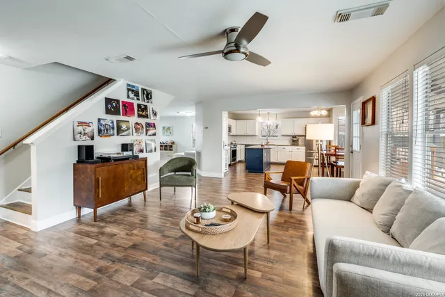 a living room with furniture and a wooden floor