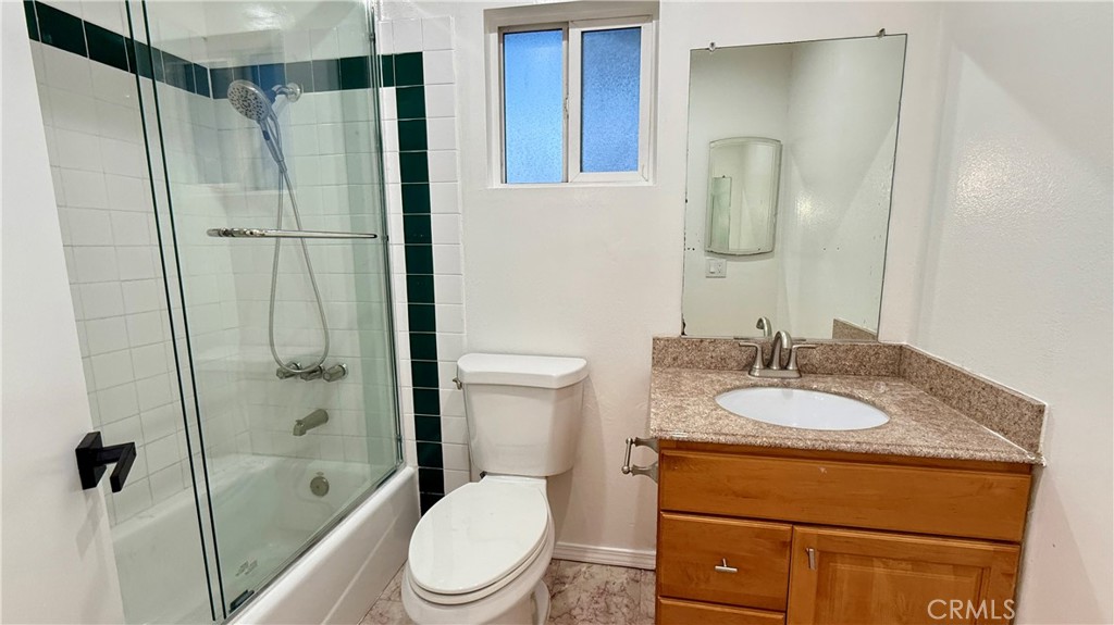 13434 Randsburg Street Cerritos, CA 90703 - Photo 13 of 13 a bathroom with a granite countertop sink toilet and shower
