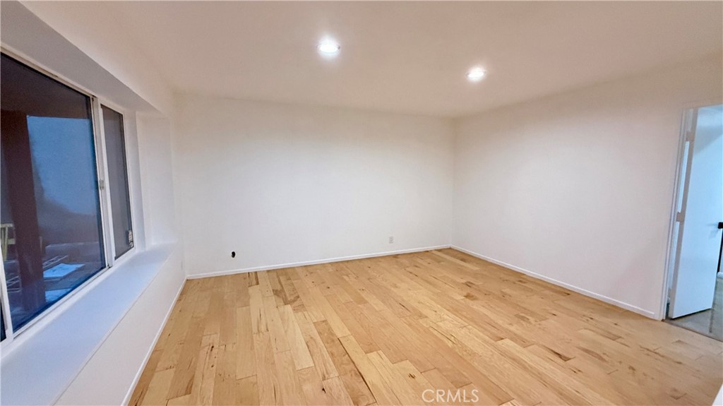 13434 Randsburg Street Cerritos, CA 90703 - Photo 2 of 13 a view of empty room with wooden floor and fan
