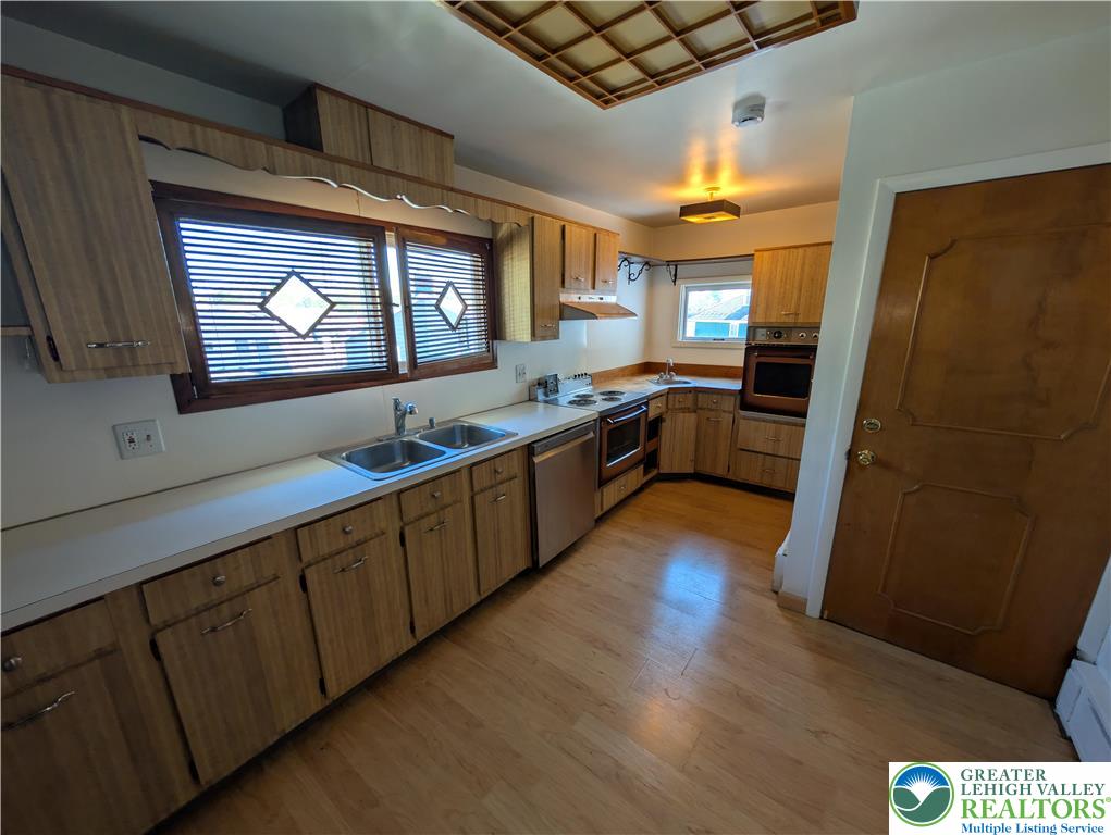 950 South 25th Street, Unit 1 Easton, PA 18042 - Photo 2 of 16 a kitchen with stainless steel appliances granite countertop a refrigerator a sink and wooden cabinets
