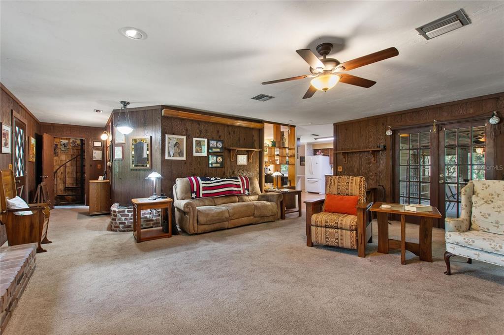 3641 Turtle Mound Road Melbourne, FL 32934 - Photo 23 of 77 a living room with furniture and a chandelier