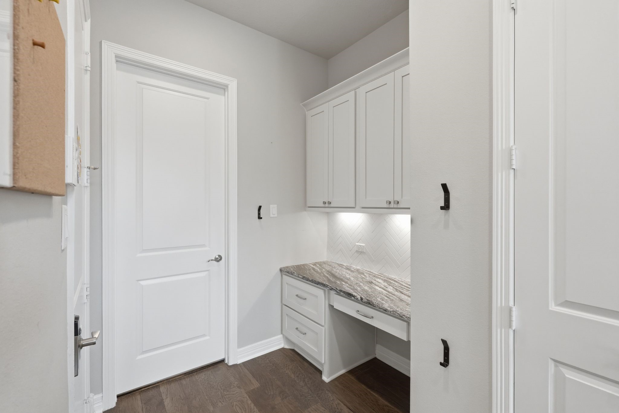 27705 South Slate Hills Lane Spring, TX 77386 - Photo 15 of 45 Highly functional hallway built-ins providing maximized storage and a dedicated desk nook. This area is in the kitchen and leads to the garage and the other door leads to the laundry room.