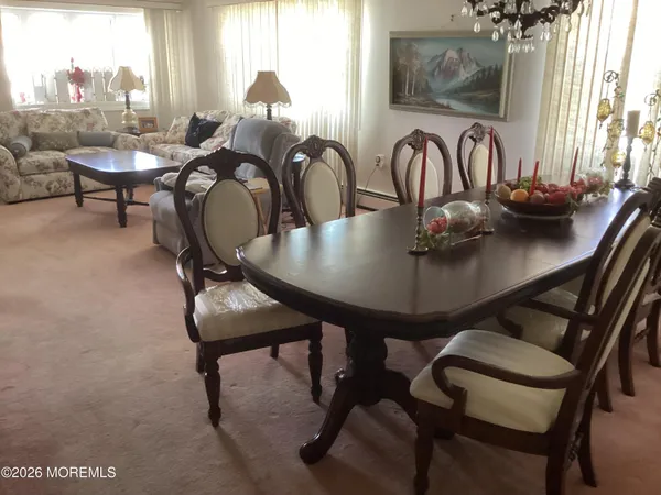 a view of a dining room with furniture and window