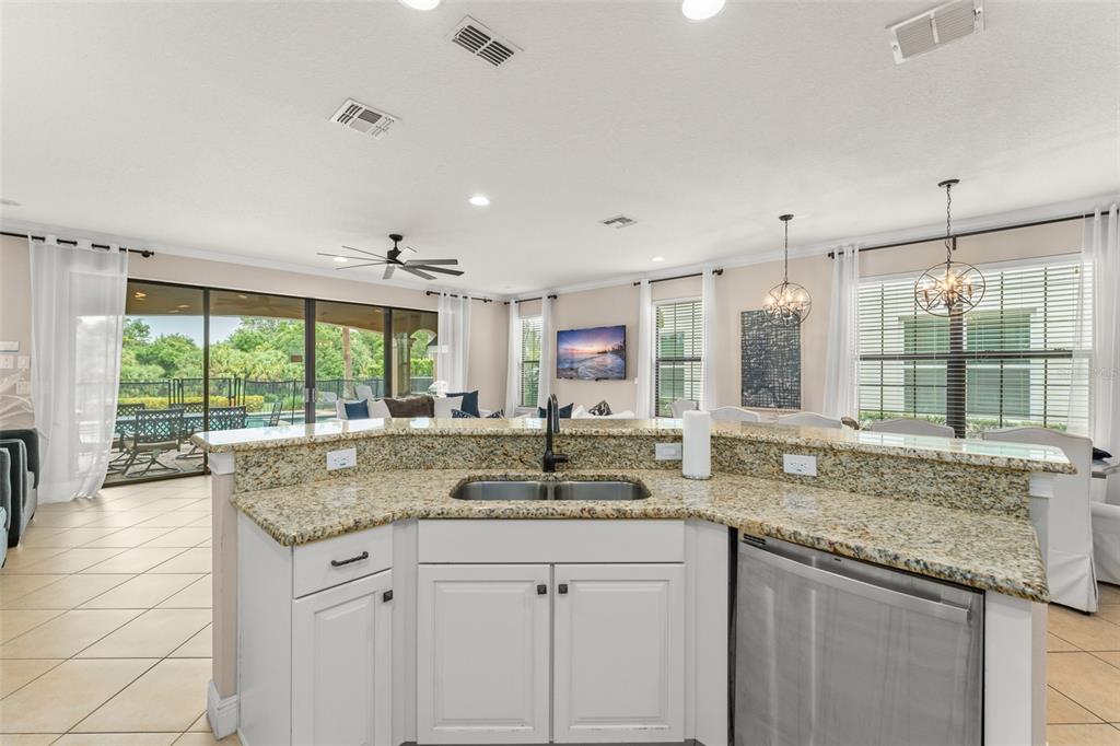 717 Desert Mountain Court Reunion, FL 34747 - Photo 18 of 62 a kitchen with granite countertop a sink and a window