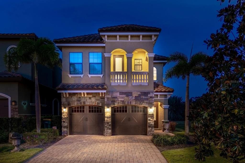 717 Desert Mountain Court Reunion, FL 34747 - Photo 2 of 62 a front view of a house with a garden
