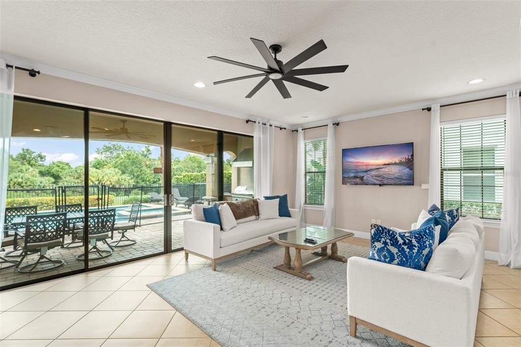 717 Desert Mountain Court Reunion, FL 34747 - Photo 23 of 62 a living room with furniture and a large window