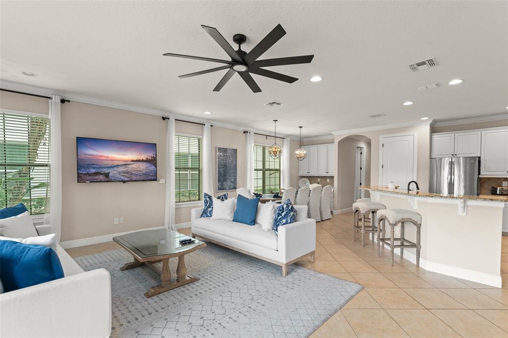 717 Desert Mountain Court Reunion, FL 34747 - Photo 24 of 62 a living room with furniture and a large window