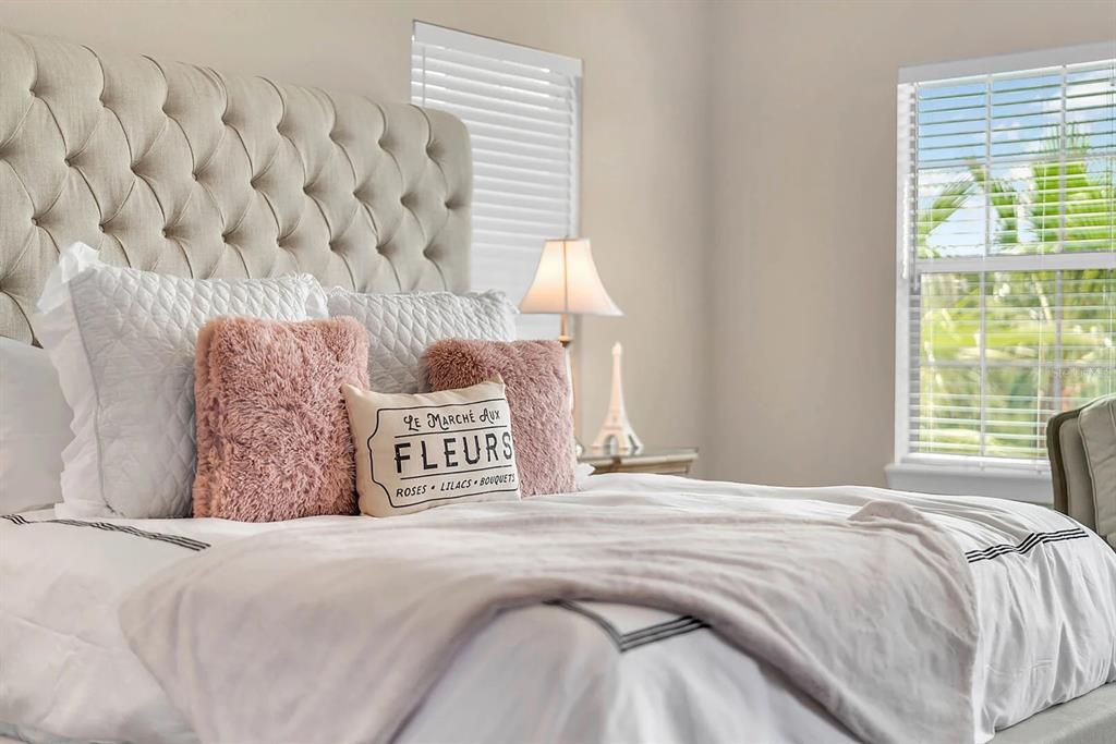717 Desert Mountain Court Reunion, FL 34747 - Photo 27 of 62 a bedroom with a bed and a window