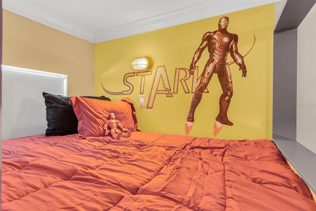 717 Desert Mountain Court Reunion, FL 34747 - Photo 45 of 62 a bedroom with a bed and a painting on the wall