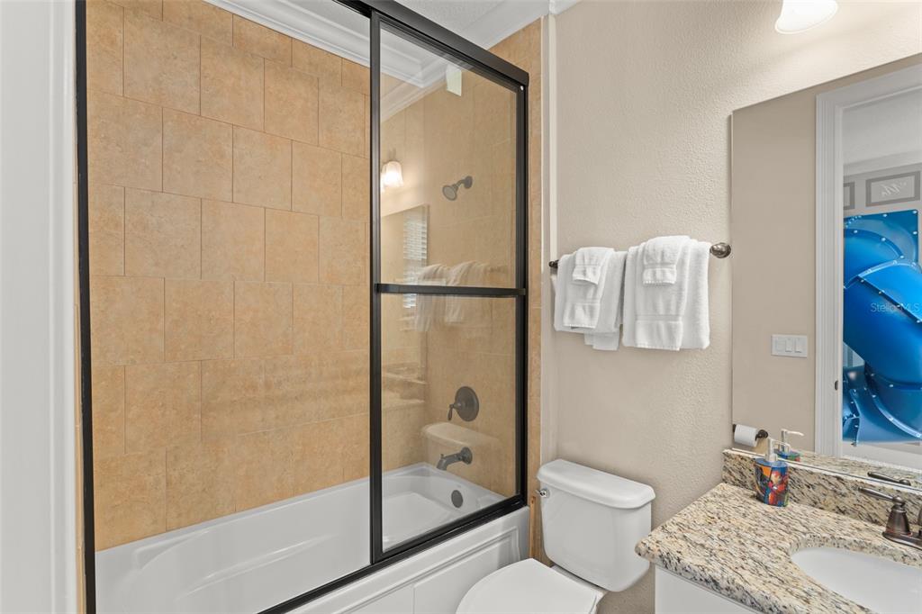 717 Desert Mountain Court Reunion, FL 34747 - Photo 46 of 62 a bathroom with a granite countertop bathtub shower sink vanity and toilet