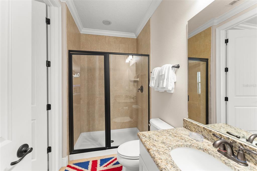 717 Desert Mountain Court Reunion, FL 34747 - Photo 49 of 62 a bathroom with a sink a toilet and shower