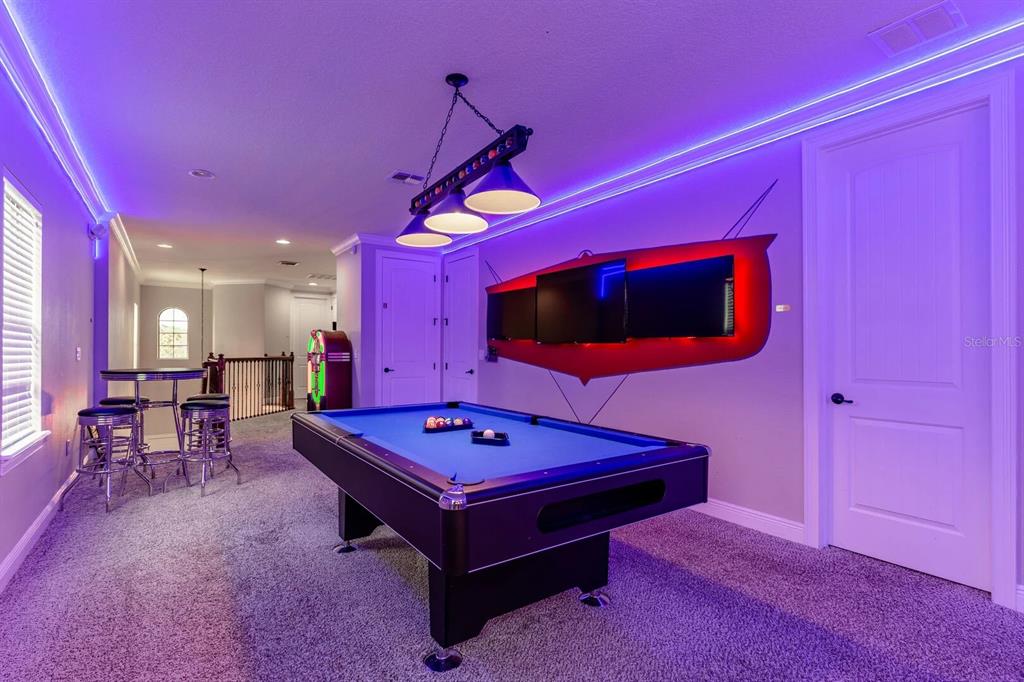 717 Desert Mountain Court Reunion, FL 34747 - Photo 5 of 62 a living room with pool table and a flat screen tv
