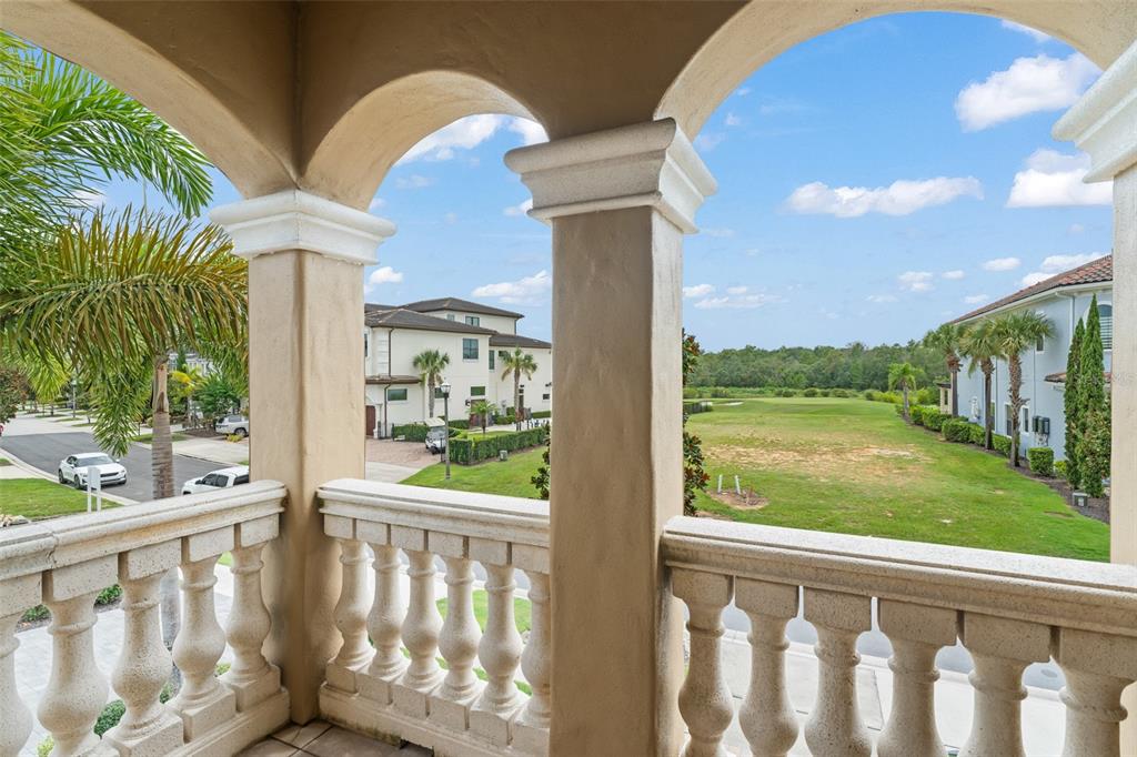 717 Desert Mountain Court Reunion, FL 34747 - Photo 51 of 62 a view of a porch with a floor to ceiling window and a yard