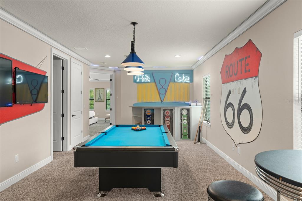 717 Desert Mountain Court Reunion, FL 34747 - Photo 6 of 62 a room with furniture a clock and a view of kitchen