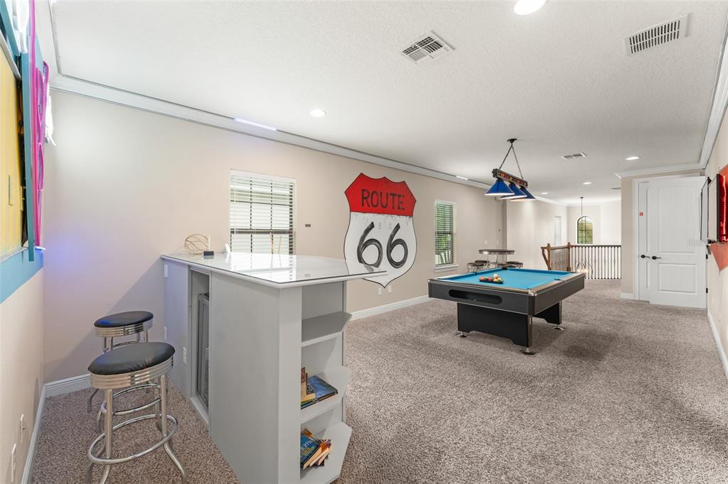 717 Desert Mountain Court Reunion, FL 34747 - Photo 10 of 62 a living room with furniture and a table