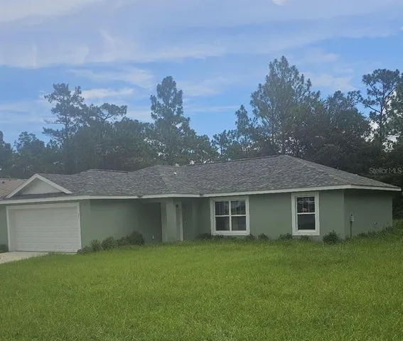 front view of a house with a garden