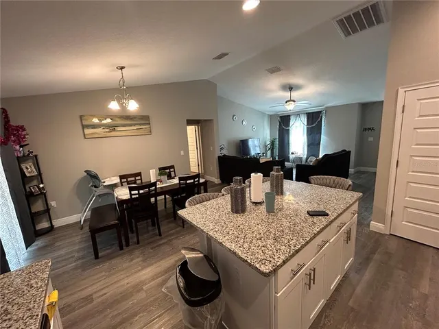 a kitchen with a dining table and chairs