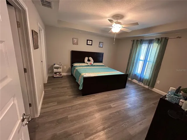 a bedroom with a bed and a chandelier