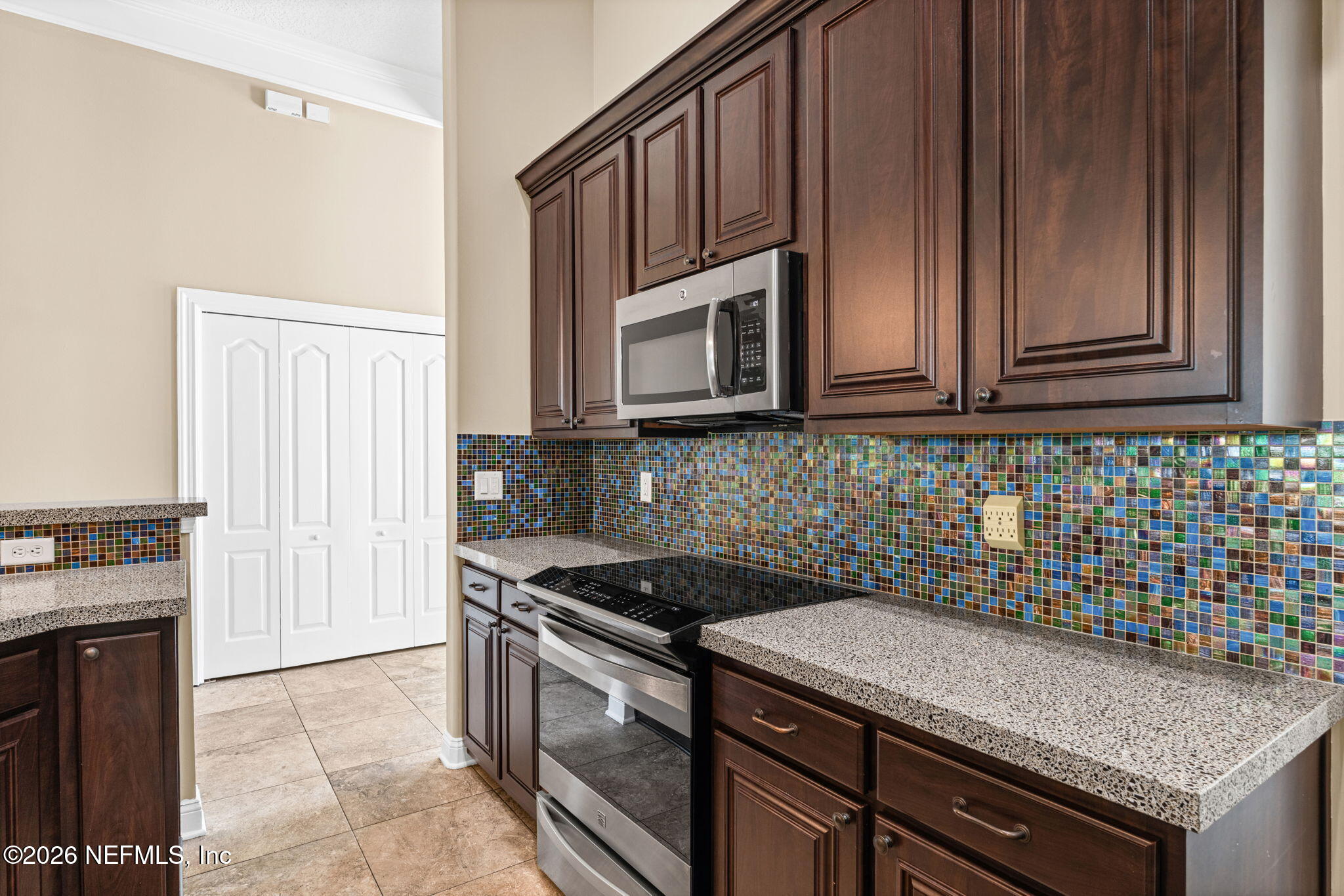 1600 Spring Water Court Fleming Island, FL 32003 - Photo 27 of 85 a kitchen with granite countertop cabinets stove and microwave
