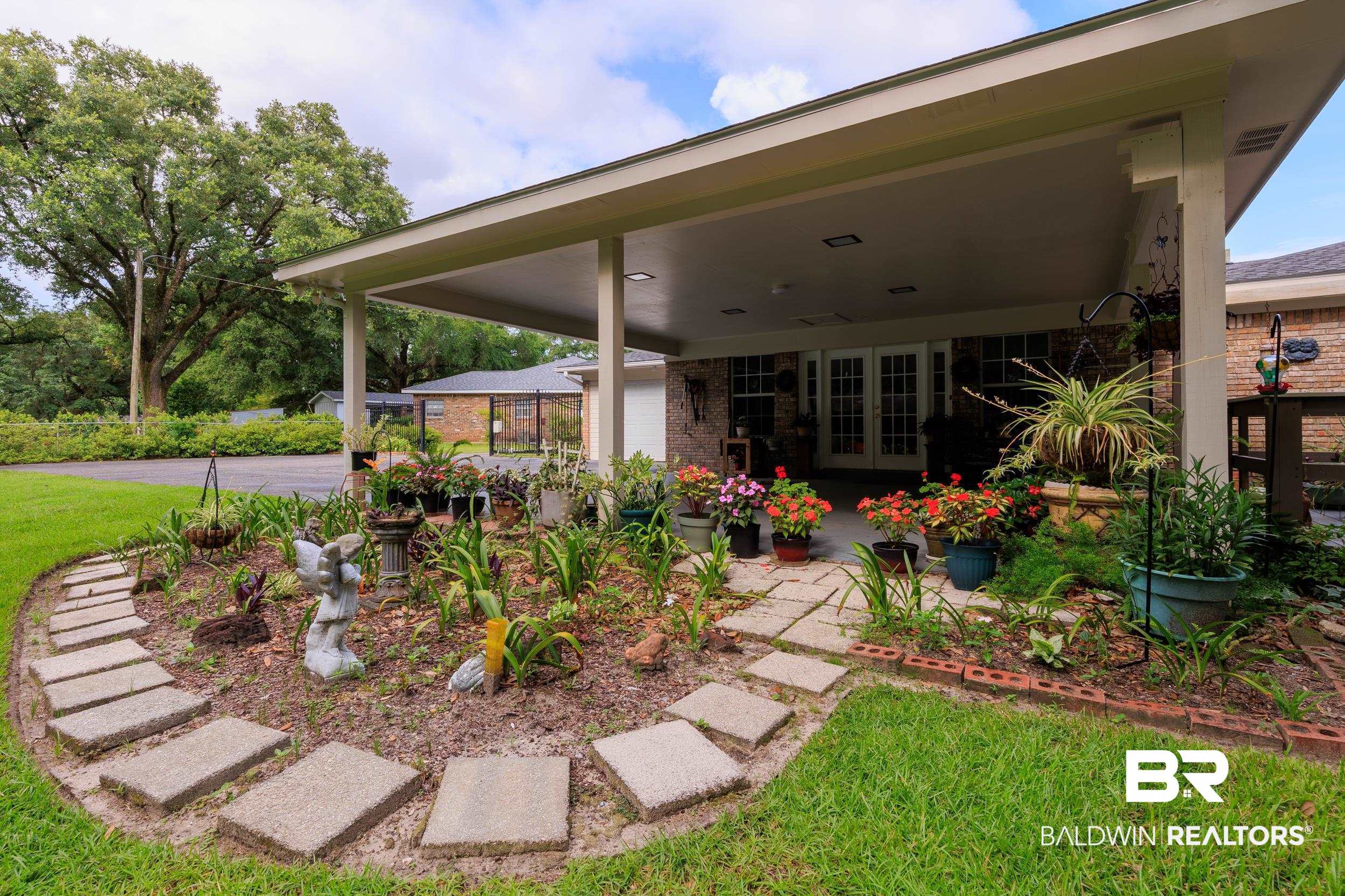1367 Spring Valley Court Mobile, AL 36693 - Photo 21 of 29 Expansive covered patio featuring a concrete slab, recessed lighting, and brick-column supports